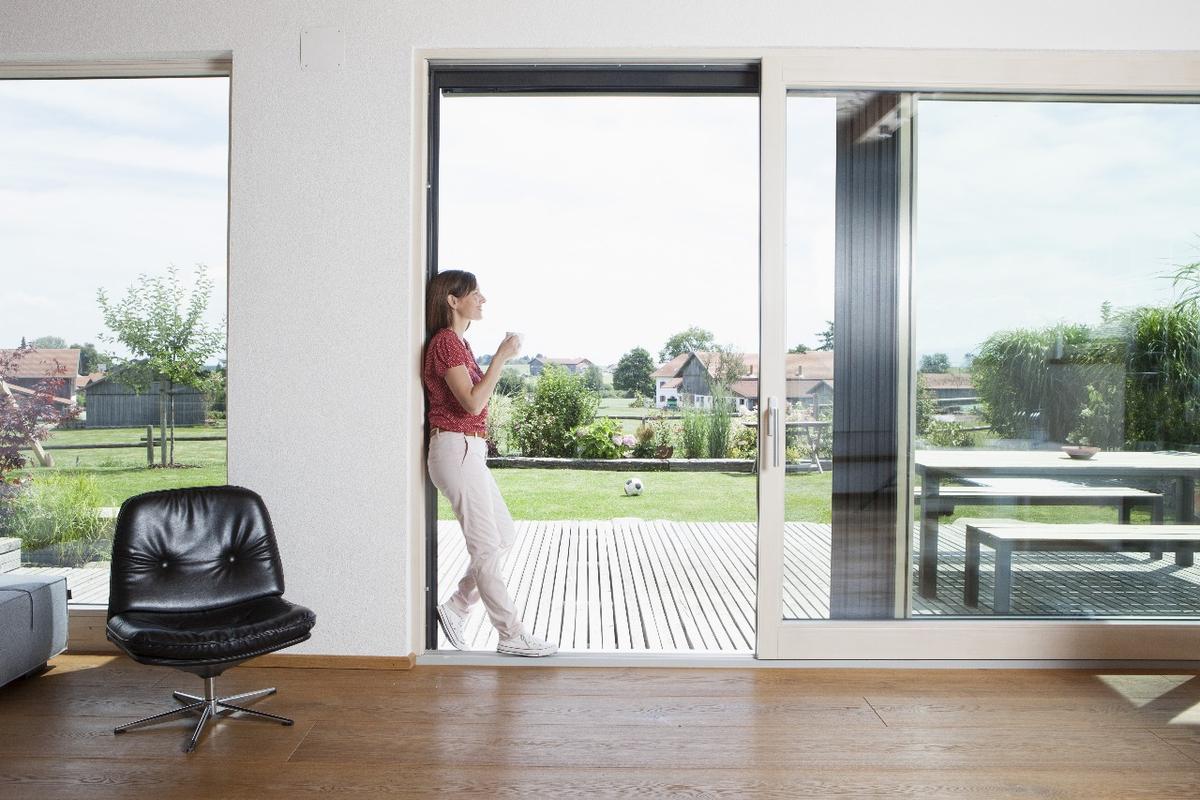 Technician inspecting a noisy sliding glass door in Fort Lauderdale